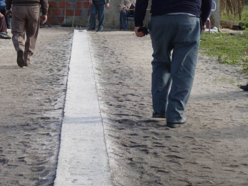 The men are congregating round an arrow-straight concrete strip about 20 meters long. 